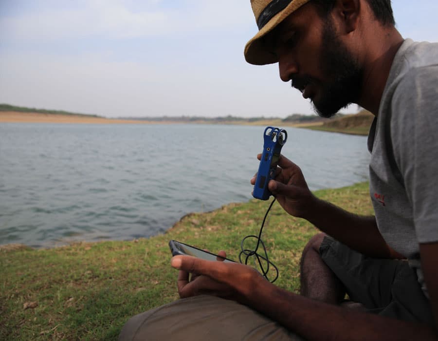 A field researcher monitoring gharial activity beside the Chambal River