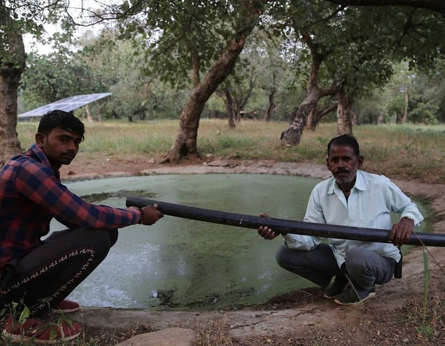 Astral Foundation workers installing a wildlife water pipeline beside a forest water point