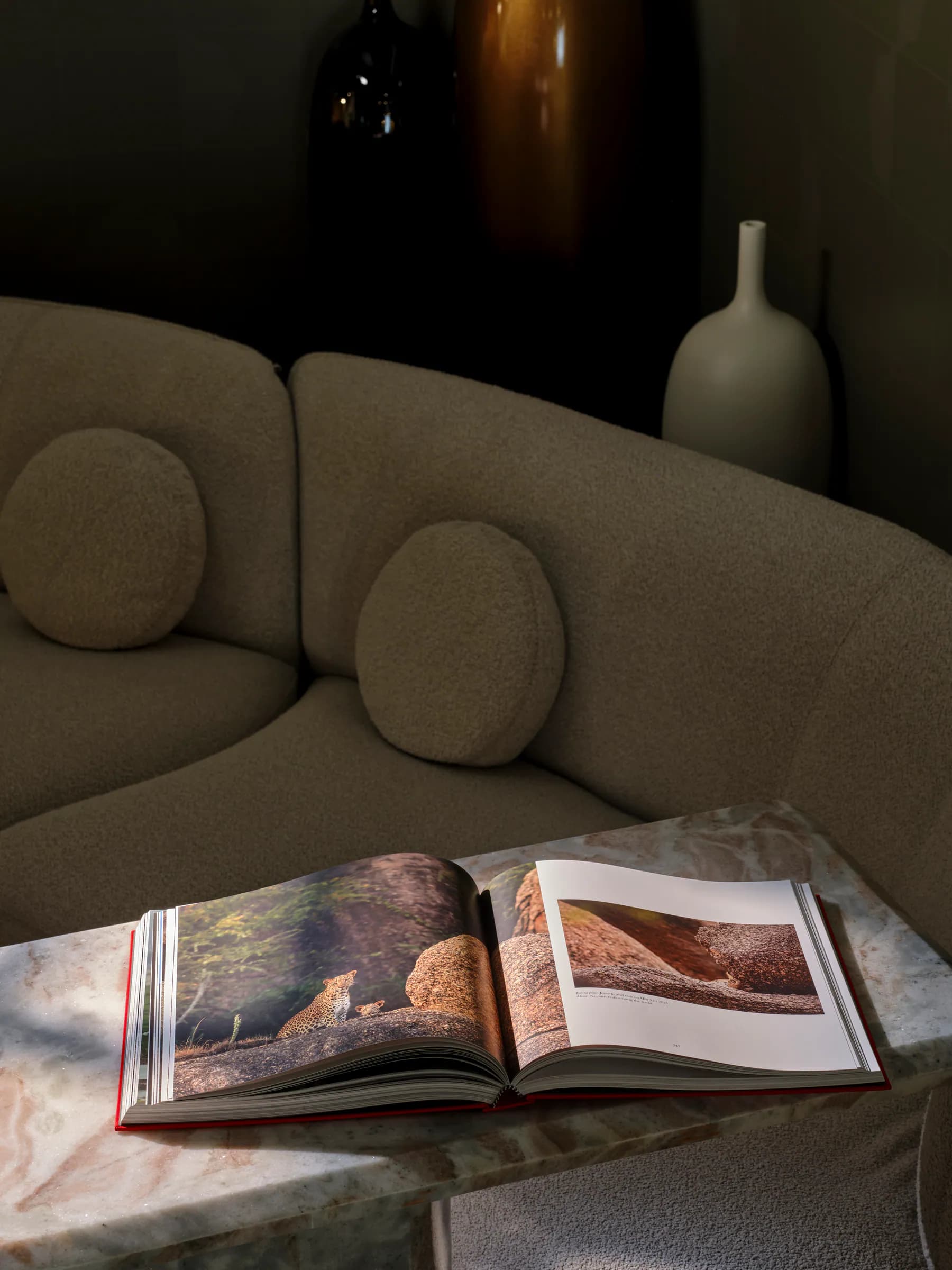 Open Ghosts of the Granite Hills book displayed on a marble table in a quiet lounge